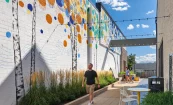 Birch & Broad, retail reposition and elevated retail alley with plants, seating, and wall mural