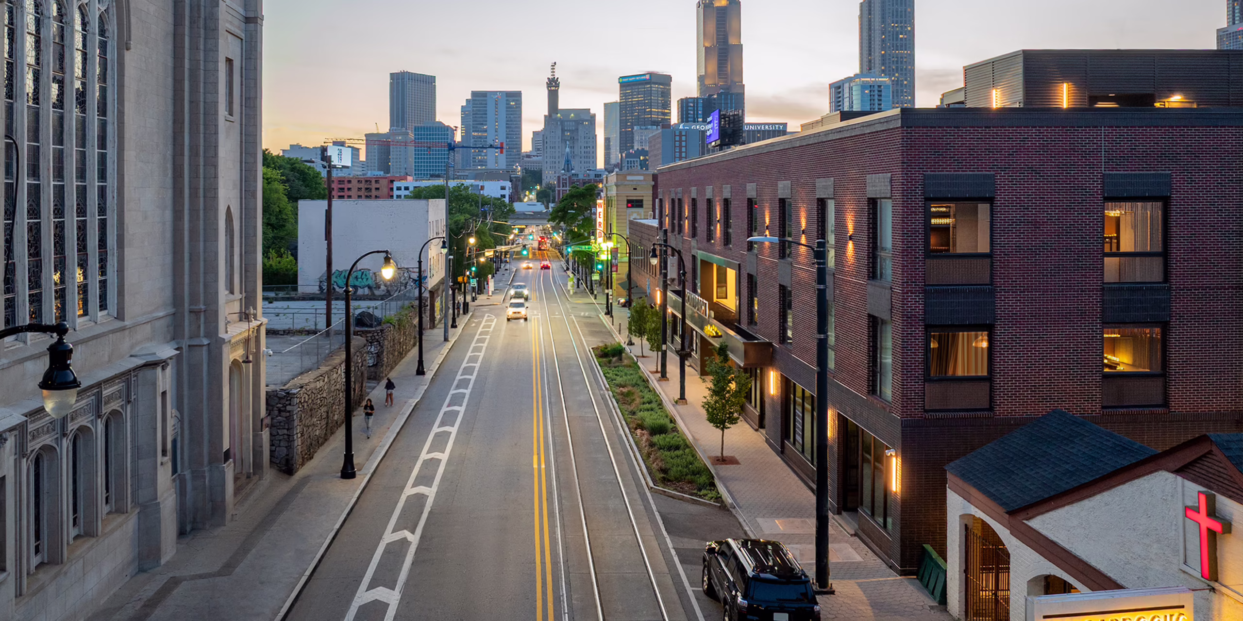 Auburn Avenue view with Front Porch building and historic Haugabrooks sign, Atlanta skyline at dusk