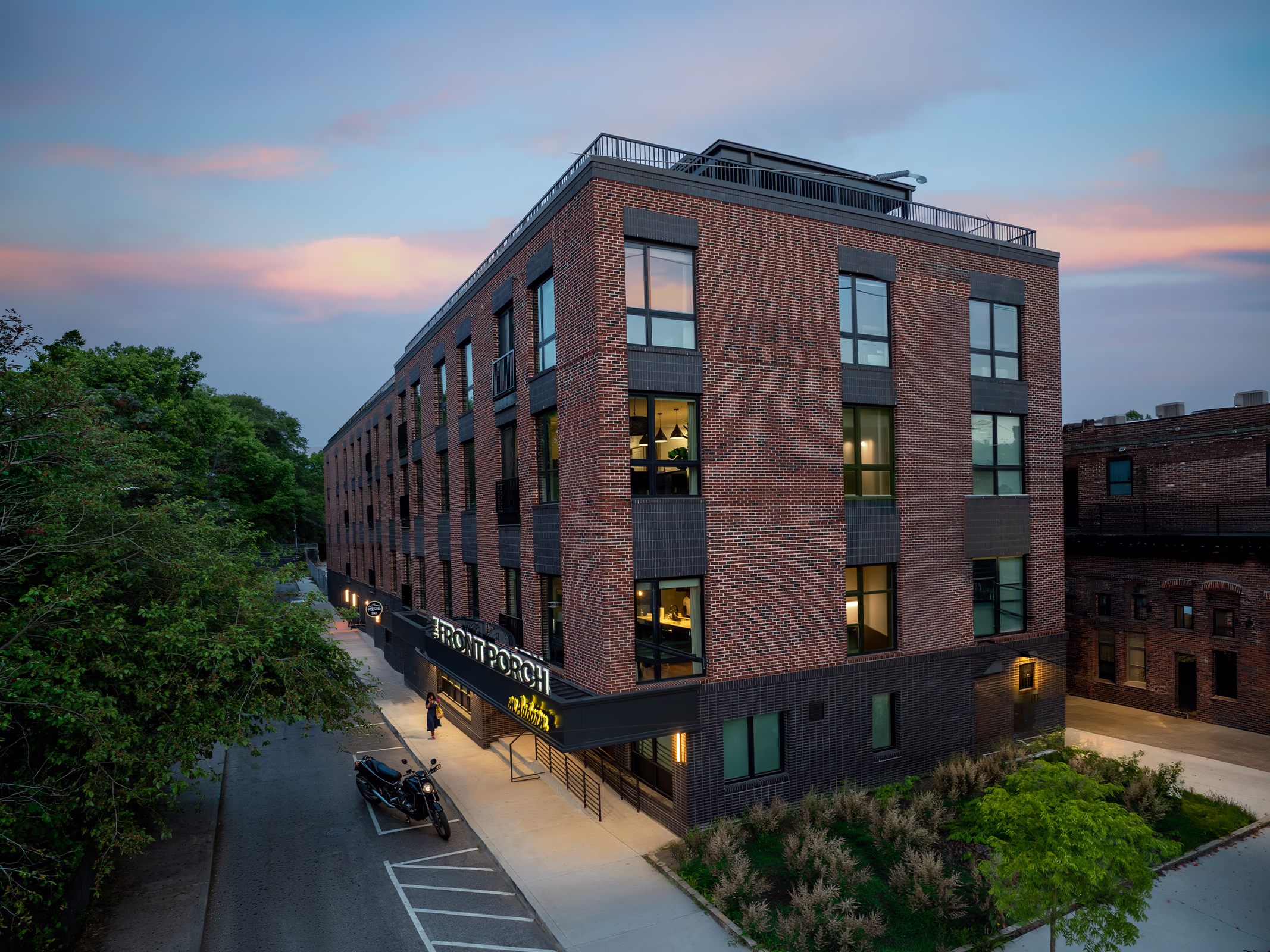 Front Porch Phase I brick building exterior at twilight, mixed-use co-living development in Atlanta