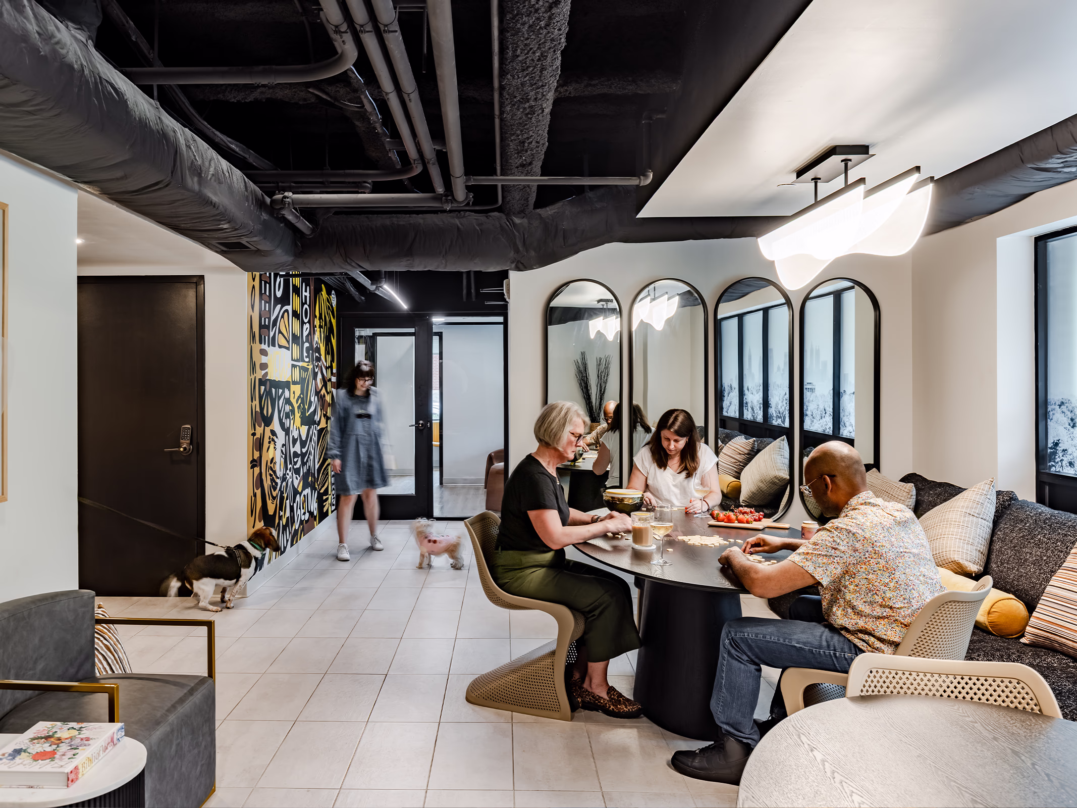 Front Porch Phase I co-living resident lounge with communal seating, mural art, and shared dining table, Atlanta