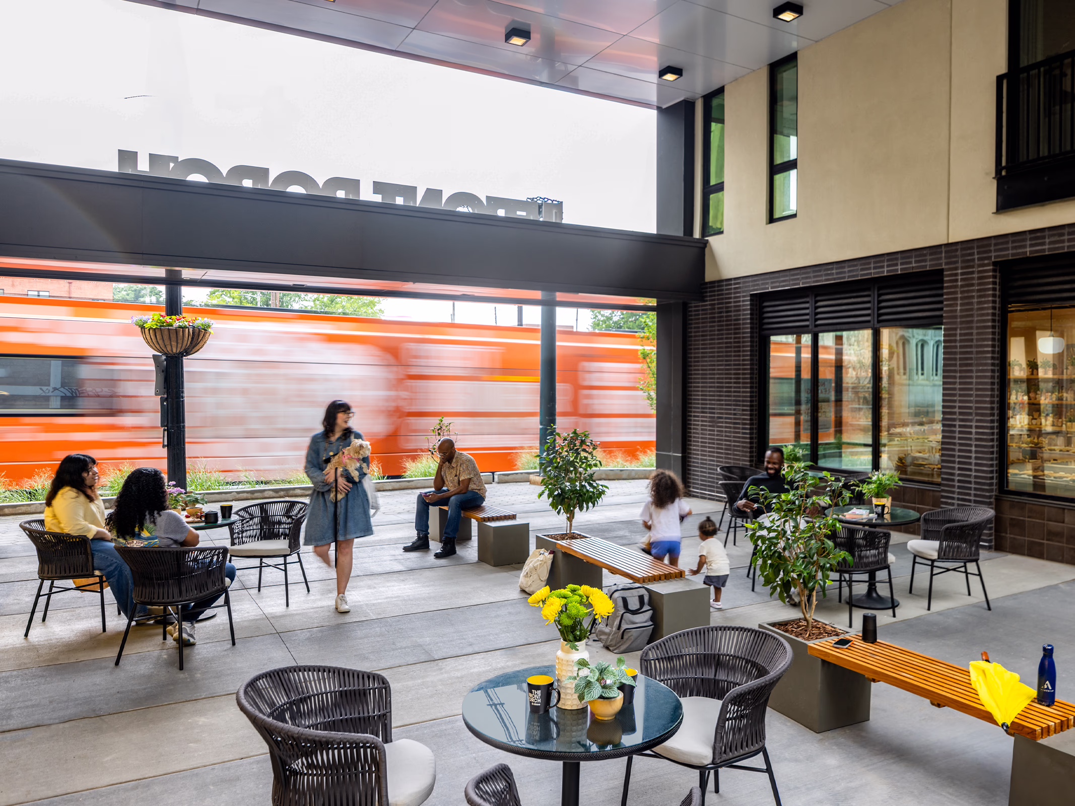 Front Porch Phase I courtyard with outdoor seating and MARTA train passing, Atlanta co-living community