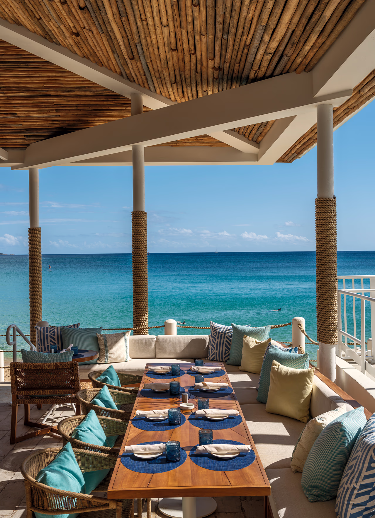 Salt Shack oceanfront dining cabana at Frenchman's Reef with rope-wrapped columns, woven chairs, and turquoise Caribbean water.