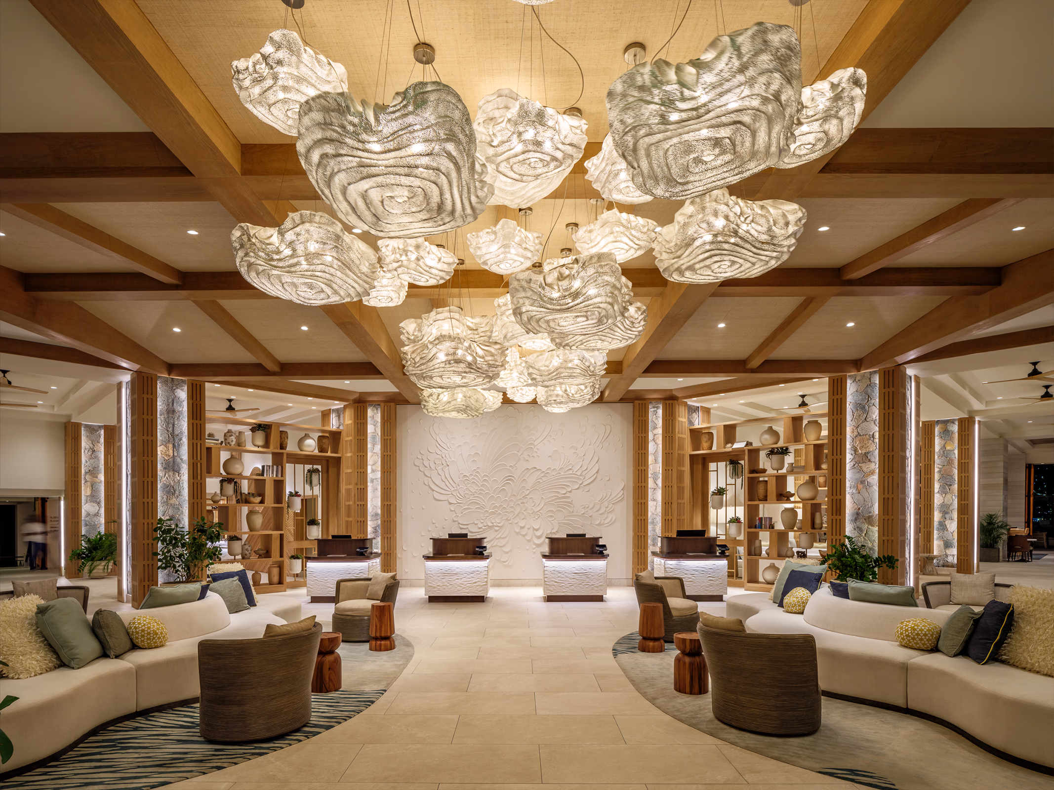 Wide night view of The Westin Frenchman's Reef lobby with cloud pendant lighting, curved sofas, and the reception desk.