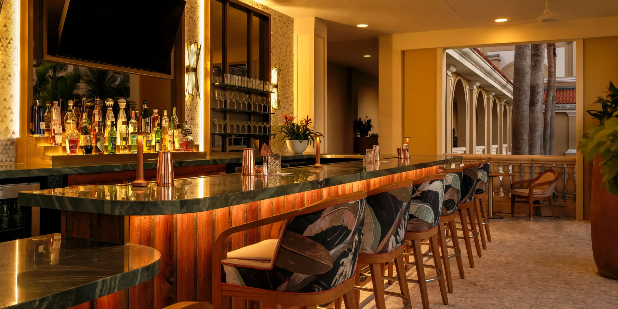 Sunset-toned bar design with natural wood and bronze accents at Rufa