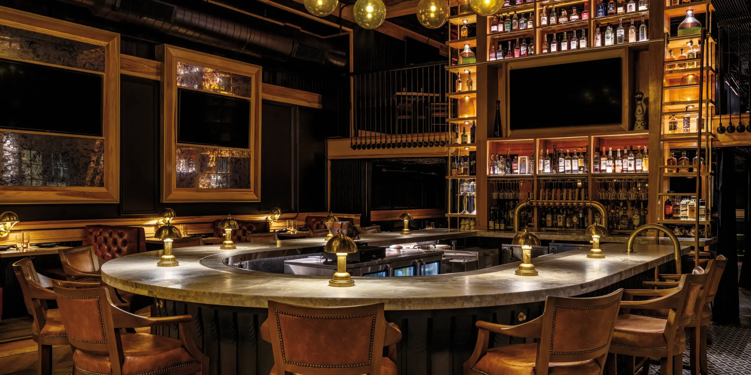 Double-height back bar with apothecary jars and liquor bottles at The Kennedy gastropub in Knoxville