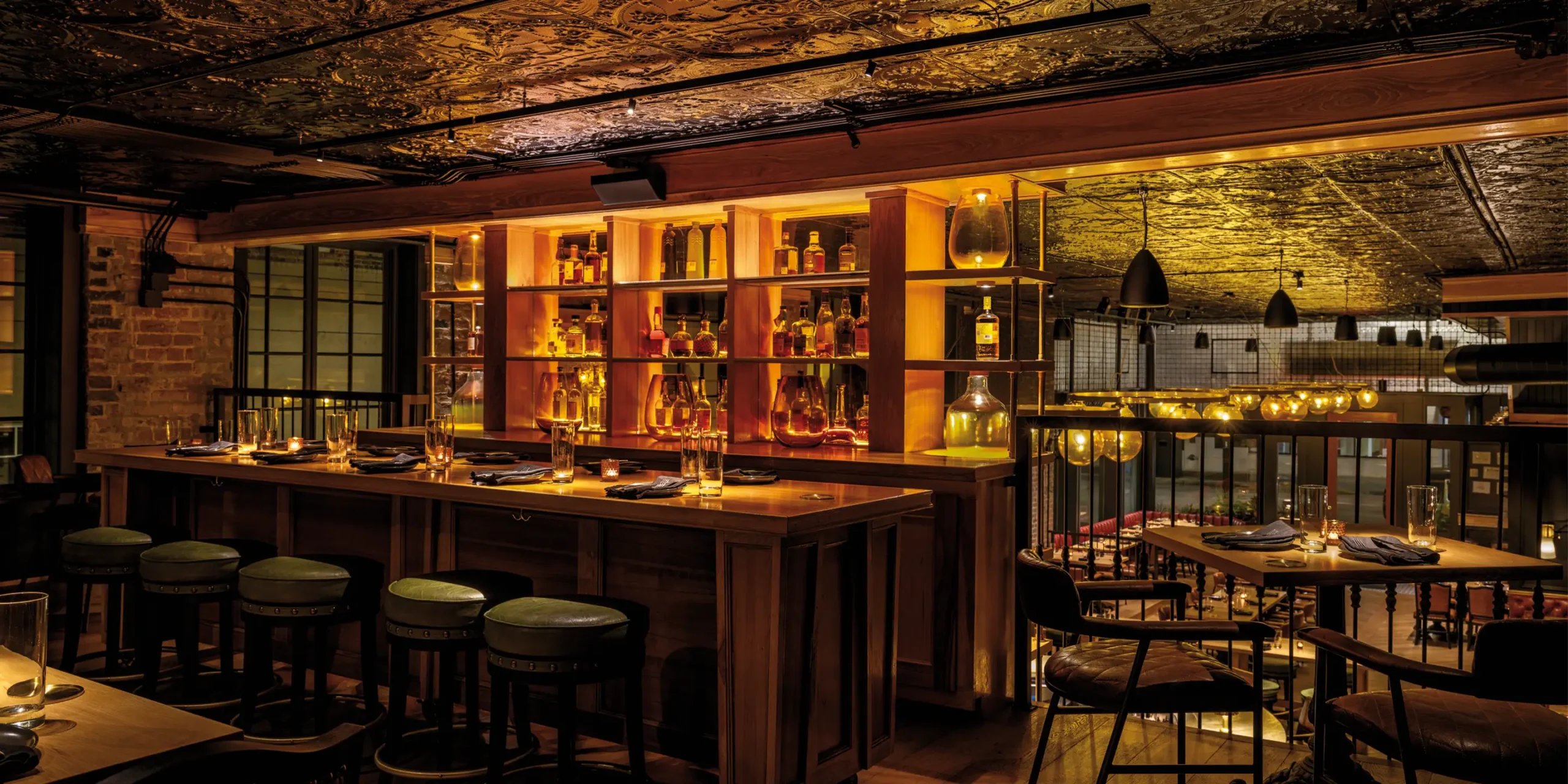 Restored black tin ceiling adding historic character to mezzanine level