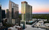 Dusk aerial view of Society Atlanta showing illuminated amenity deck and surrounding Midtown buildings