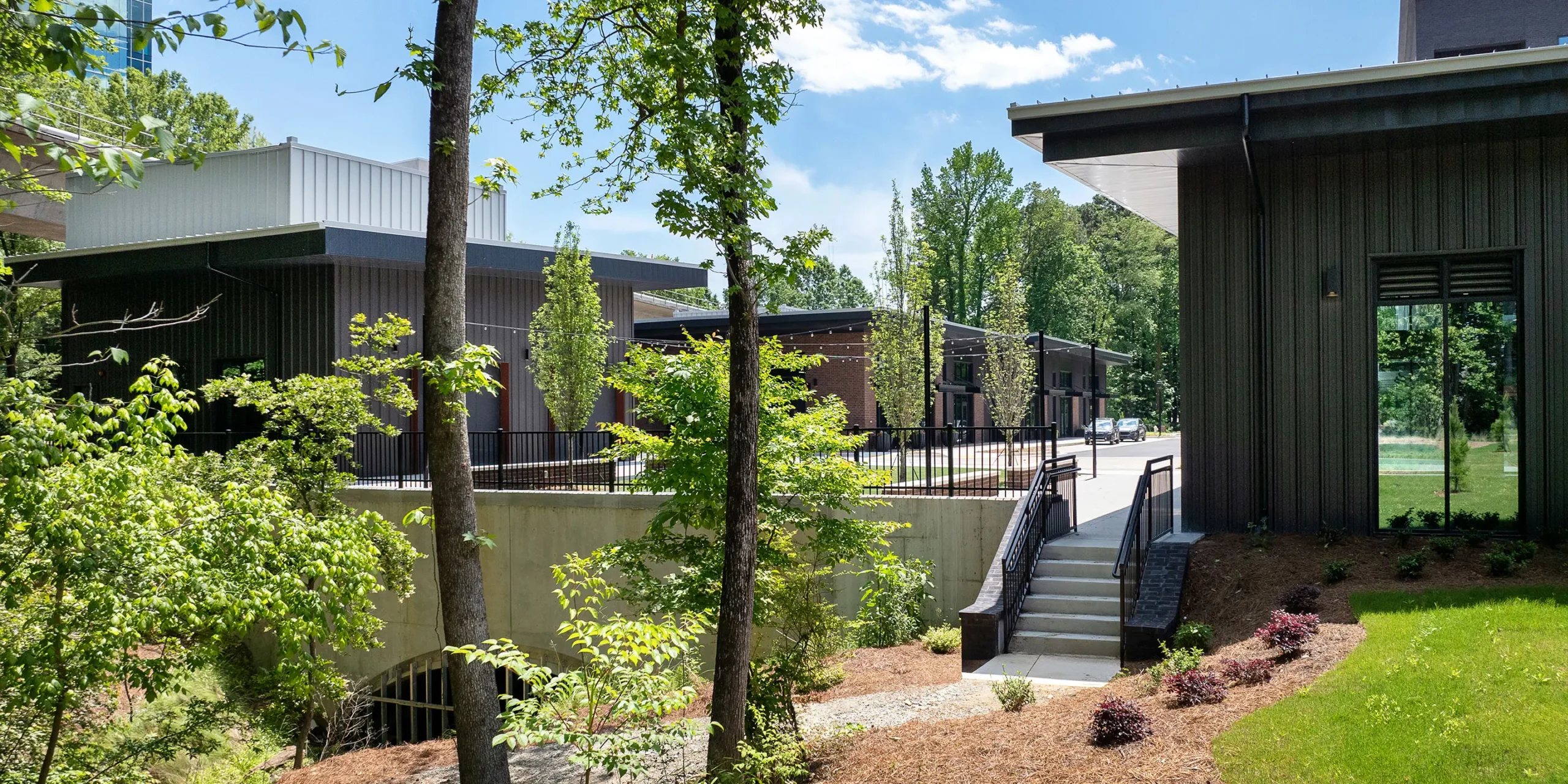 Retail buildings at AMLI Brookhaven viewed from adjacent trail.