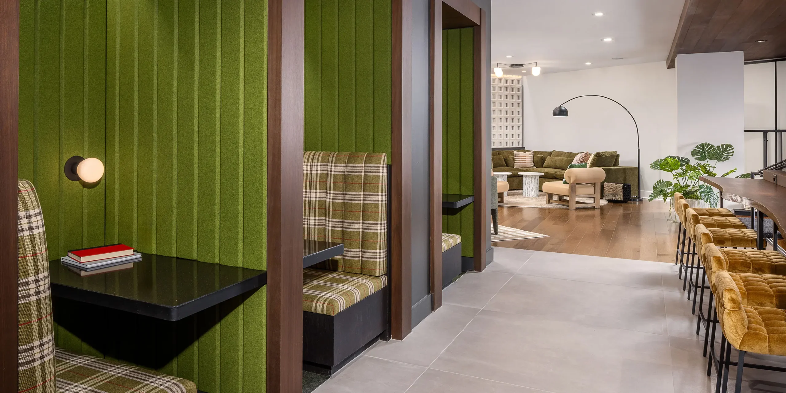 Interior lounge with bar seating, single-seat booths, and small group areas.