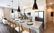 Modern apartment kitchen with custom cabinetry, island, and premium finishes at Pilot & Park.