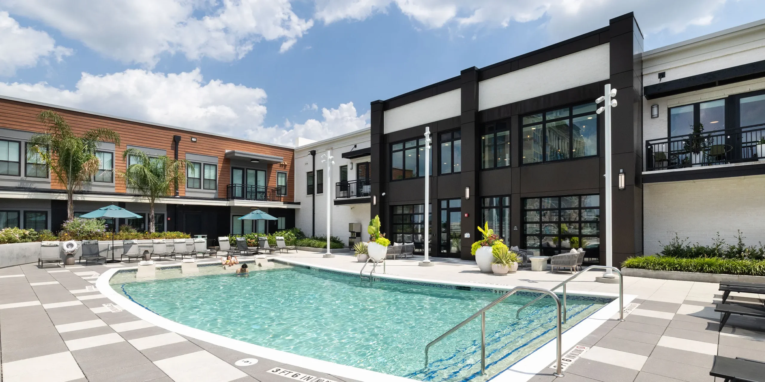 Rooftop pool at Pilot & Park with a view back into interior amenity spaces.