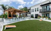 Courtyard at Pilot & Park with timber pavilion, outdoor kitchen, bar seating, and recreation areas.