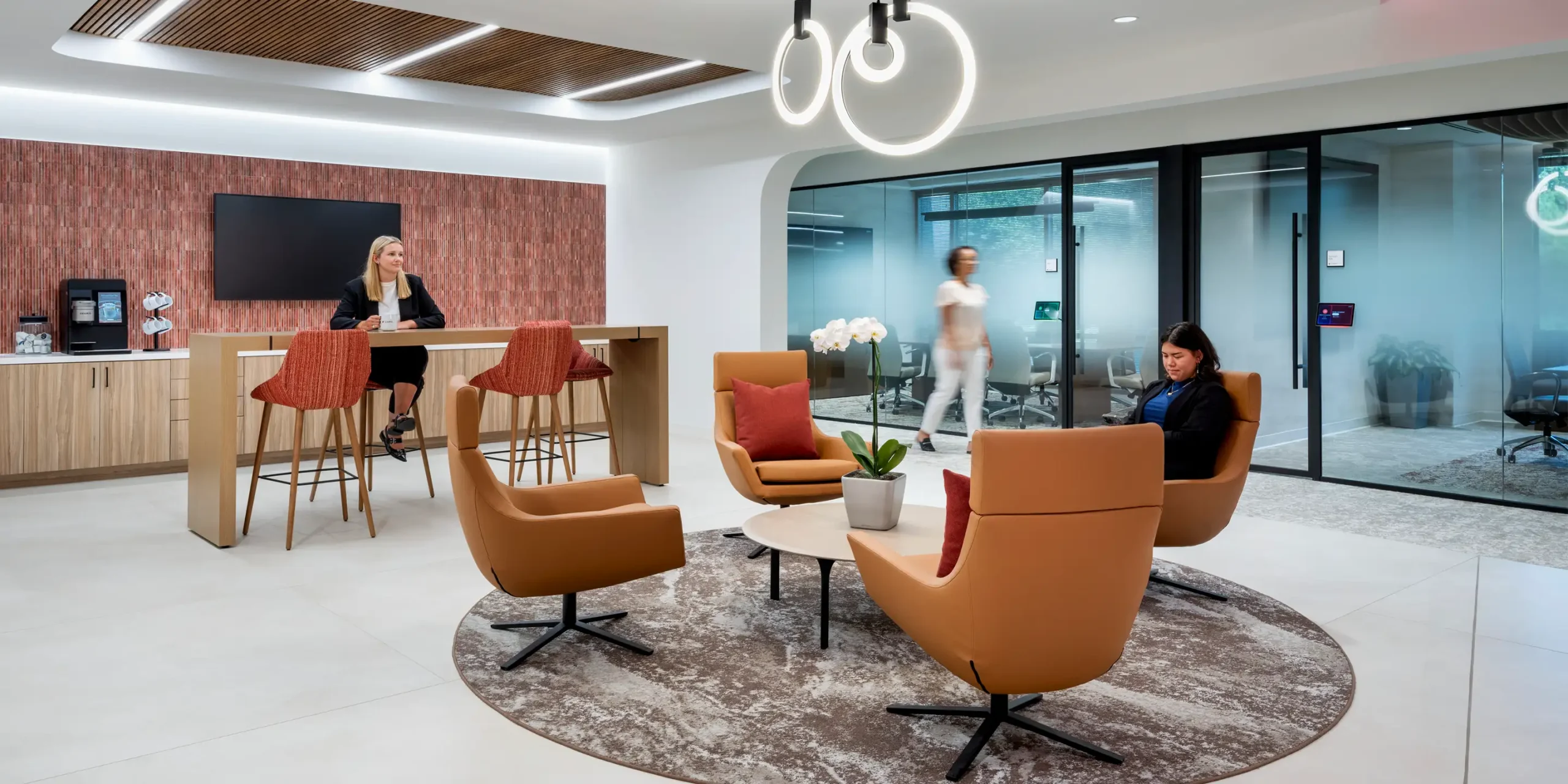 Sompo International coffee bar and round seating area with people walking and sitting.