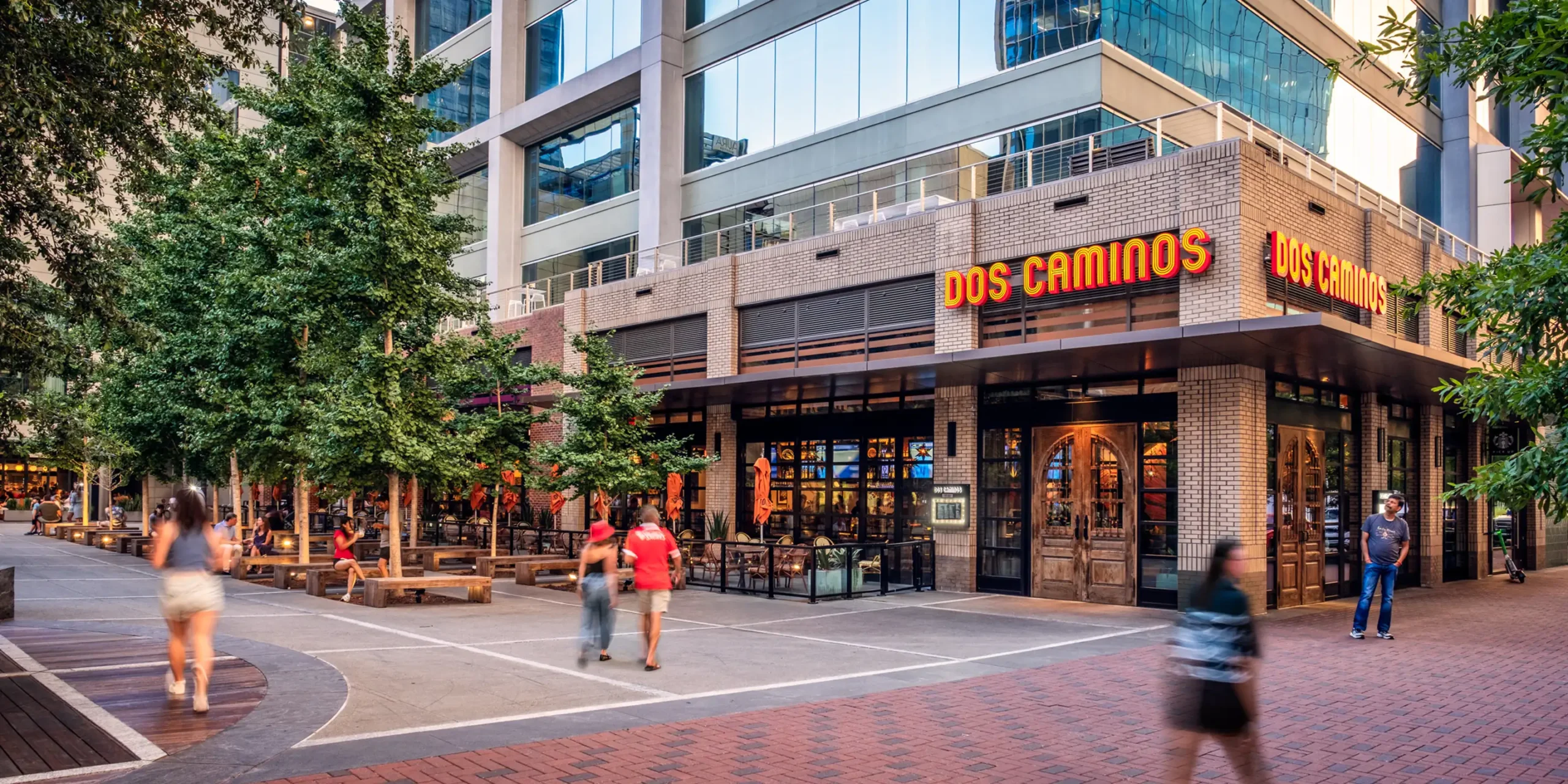 Dos Caminos exterior sign and outdoor seating at the Ally Charlotte