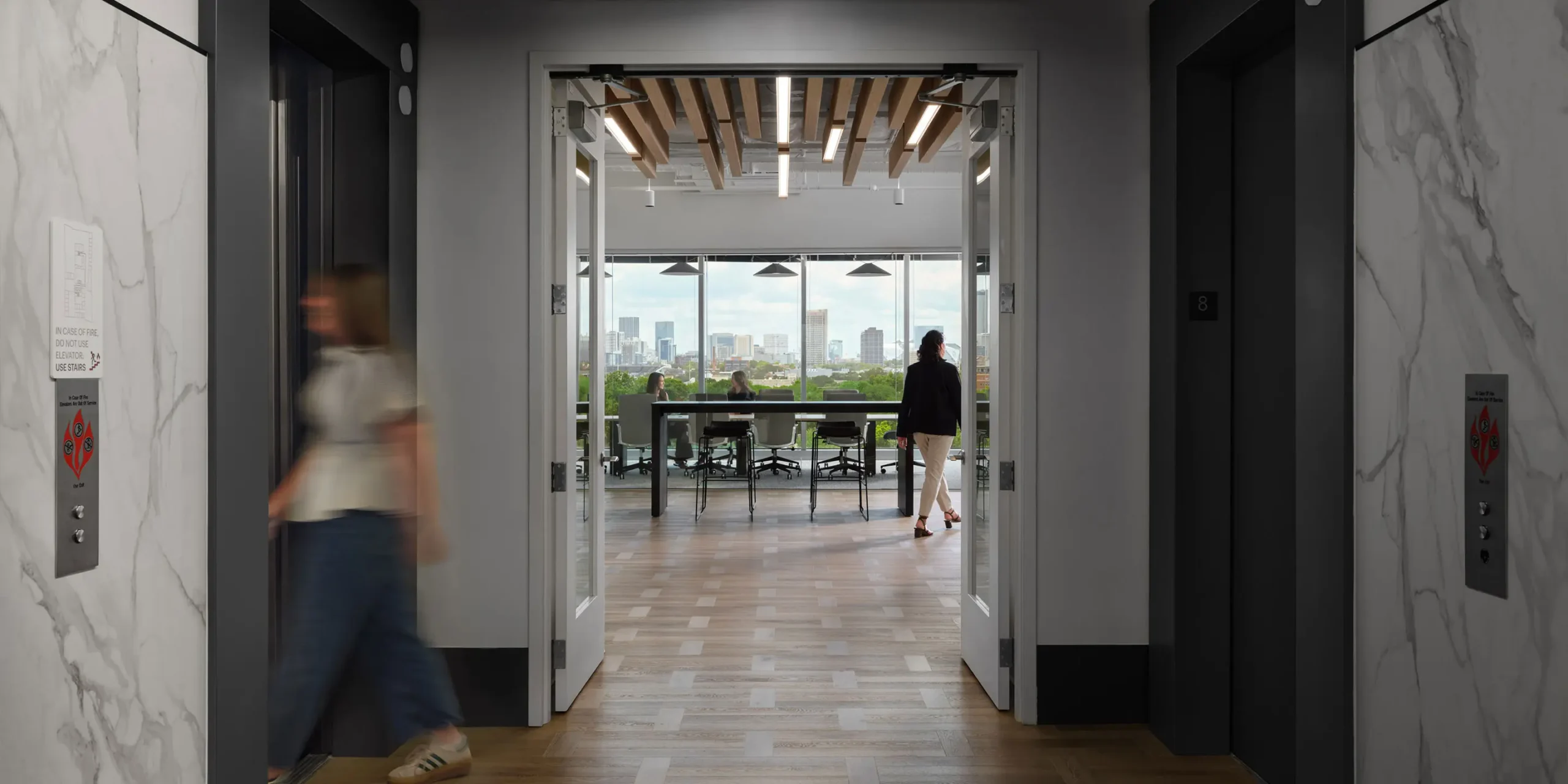 Modern corporate office lobby with natural finishes and seating, designed for Piedmont Healthcare by Cooper Carry
