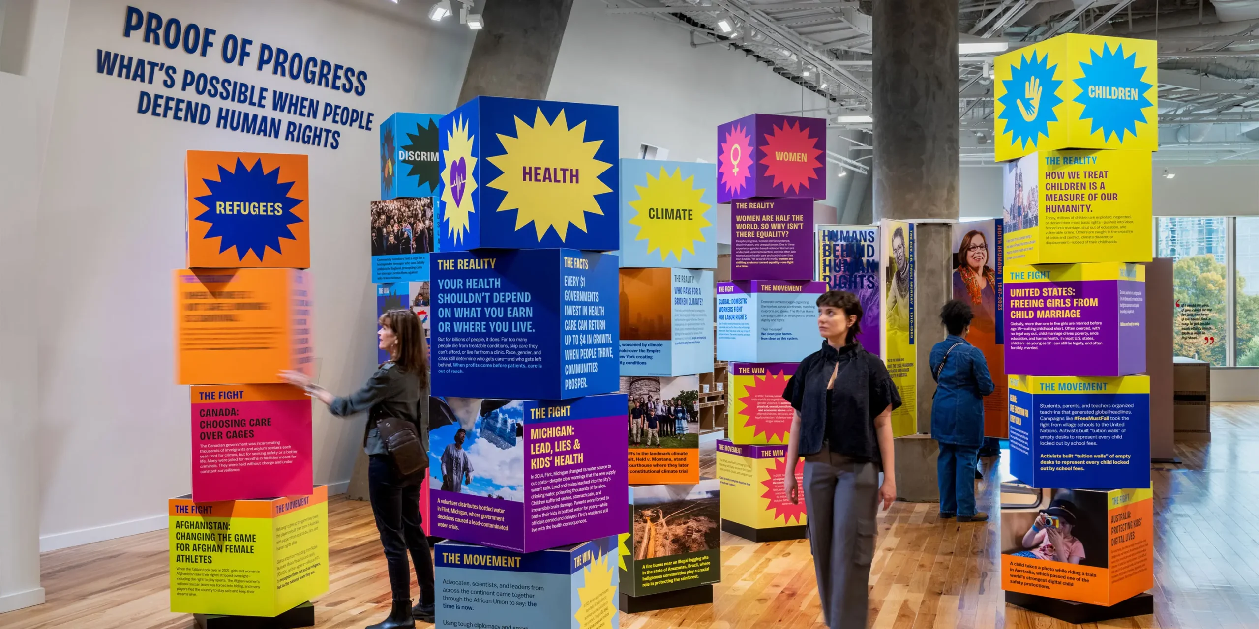 Interactive Spinning Cube Totems: Stacked, colorful cubes that rotate to reveal contemporary, global human rights struggles and wins.