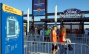 North Gate entrance with illuminated dimensional channel letters and Ford sponsorship signage, with a Stadium Information sign visible in the foreground.