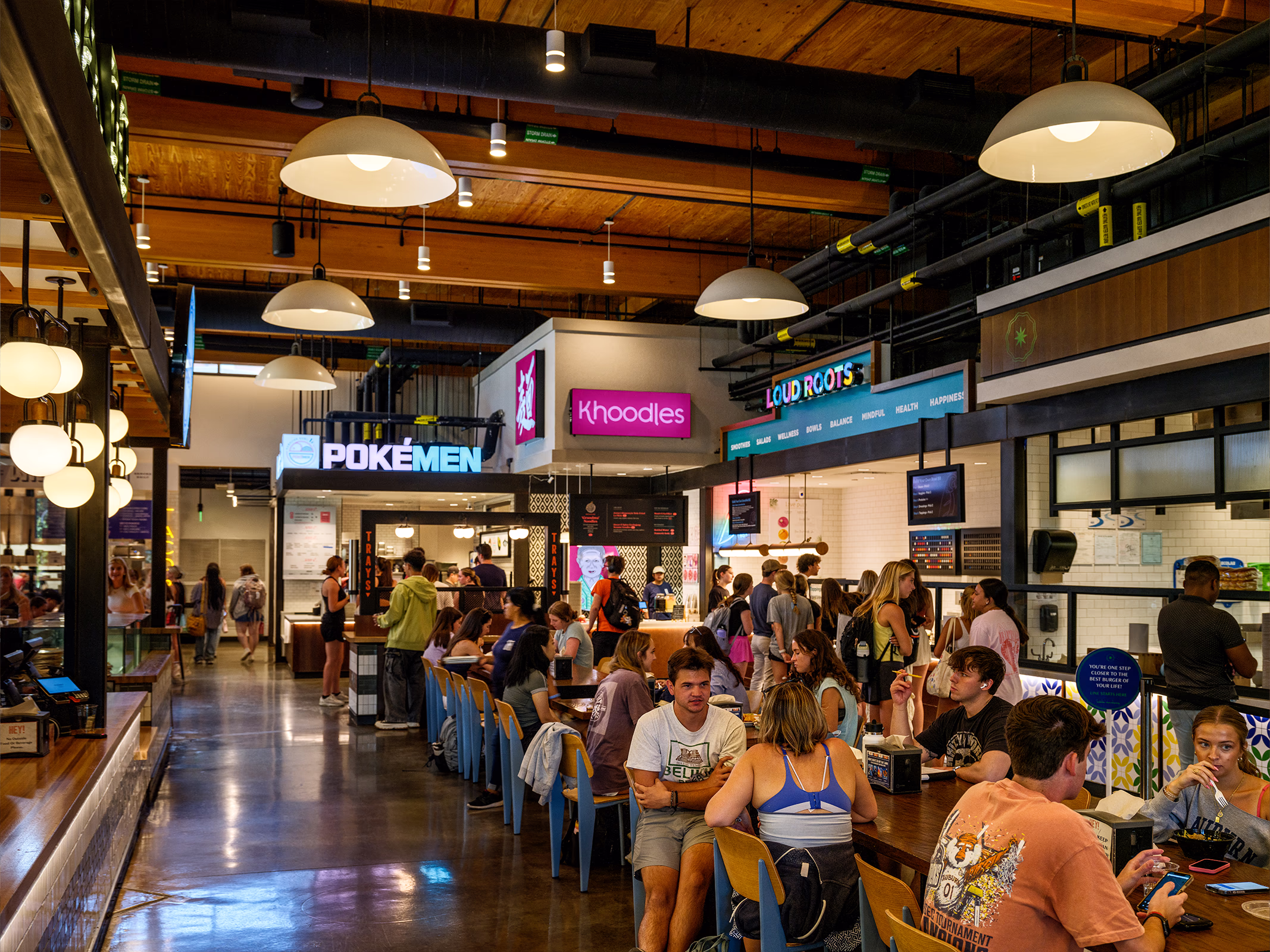 Hey Day Market food hall at The Laurel Hotel & Spa's Culinary Science Center at Auburn University, with multiple dining stalls and communal seating.